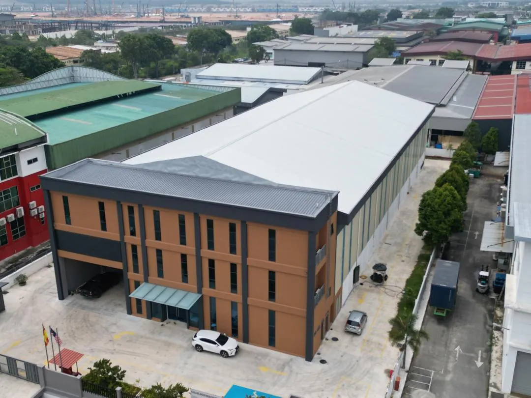 Aerial view of a detached factory with office block and compound