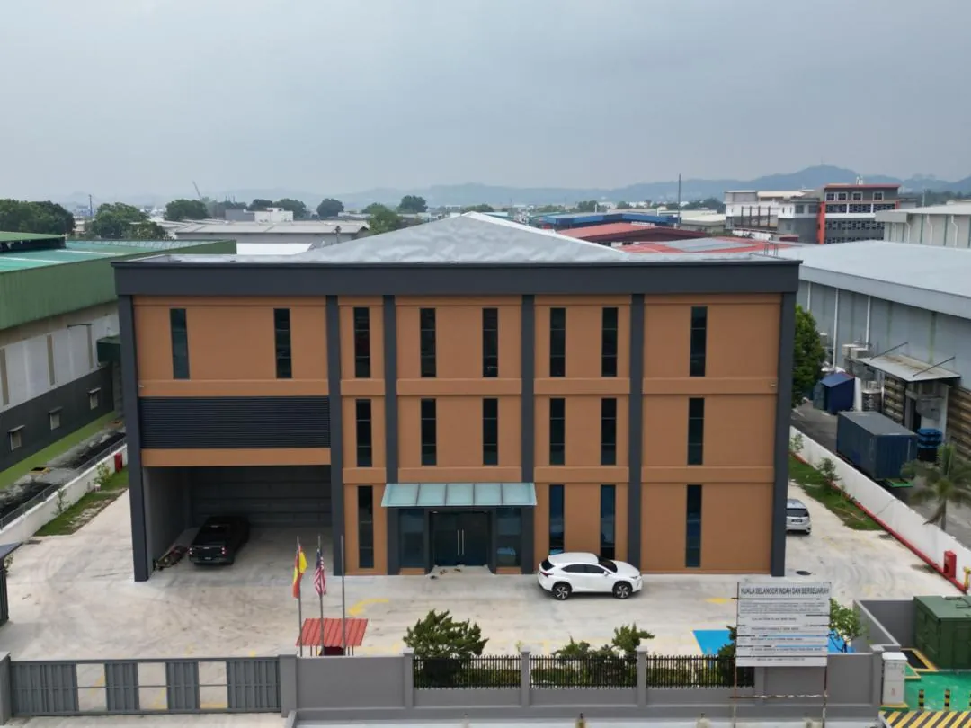 Front elevation of a detached factory with a three-storey office block